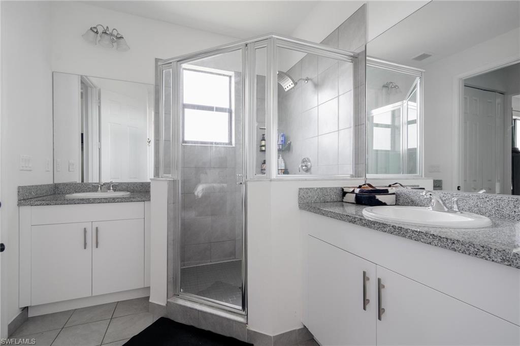 5519 Useppa Drive Ave Maria, FL 34142 - Photo 16 of 32 a bathroom with double vanity and a mirror