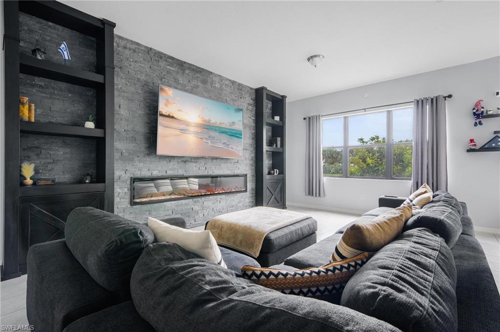 5519 Useppa Drive Ave Maria, FL 34142 - Photo 2 of 32 a living room with furniture and a flat screen tv