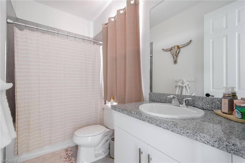 5519 Useppa Drive Ave Maria, FL 34142 - Photo 21 of 32 a bathroom with a granite countertop sink toilet and shower