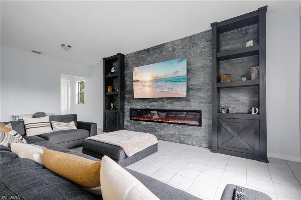 5519 Useppa Drive Ave Maria, FL 34142 - Photo 3 of 32 a living room with furniture and a flat screen tv