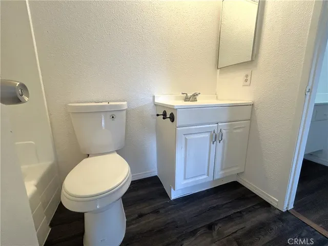 a bathroom with a toilet a sink and mirror