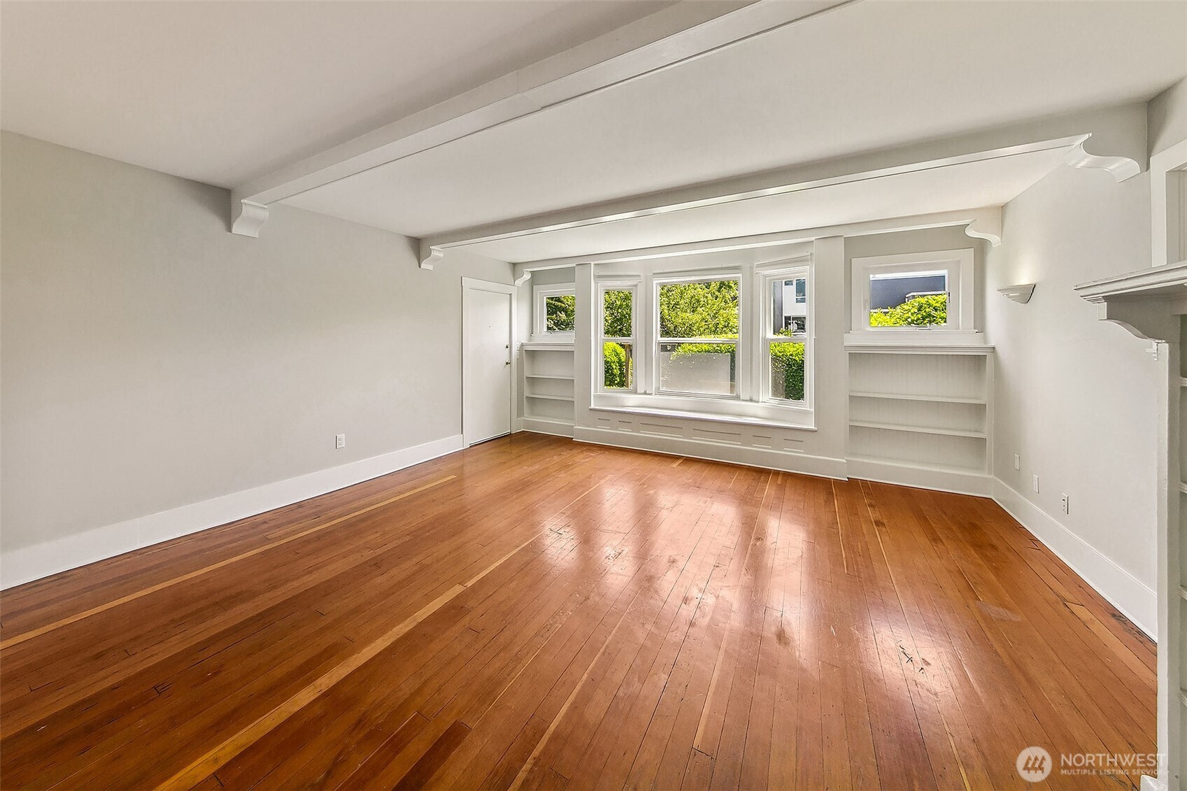 1111 18th Avenue Seattle, WA 98122 - Photo 12 of 40 an empty room with wooden floor and windows