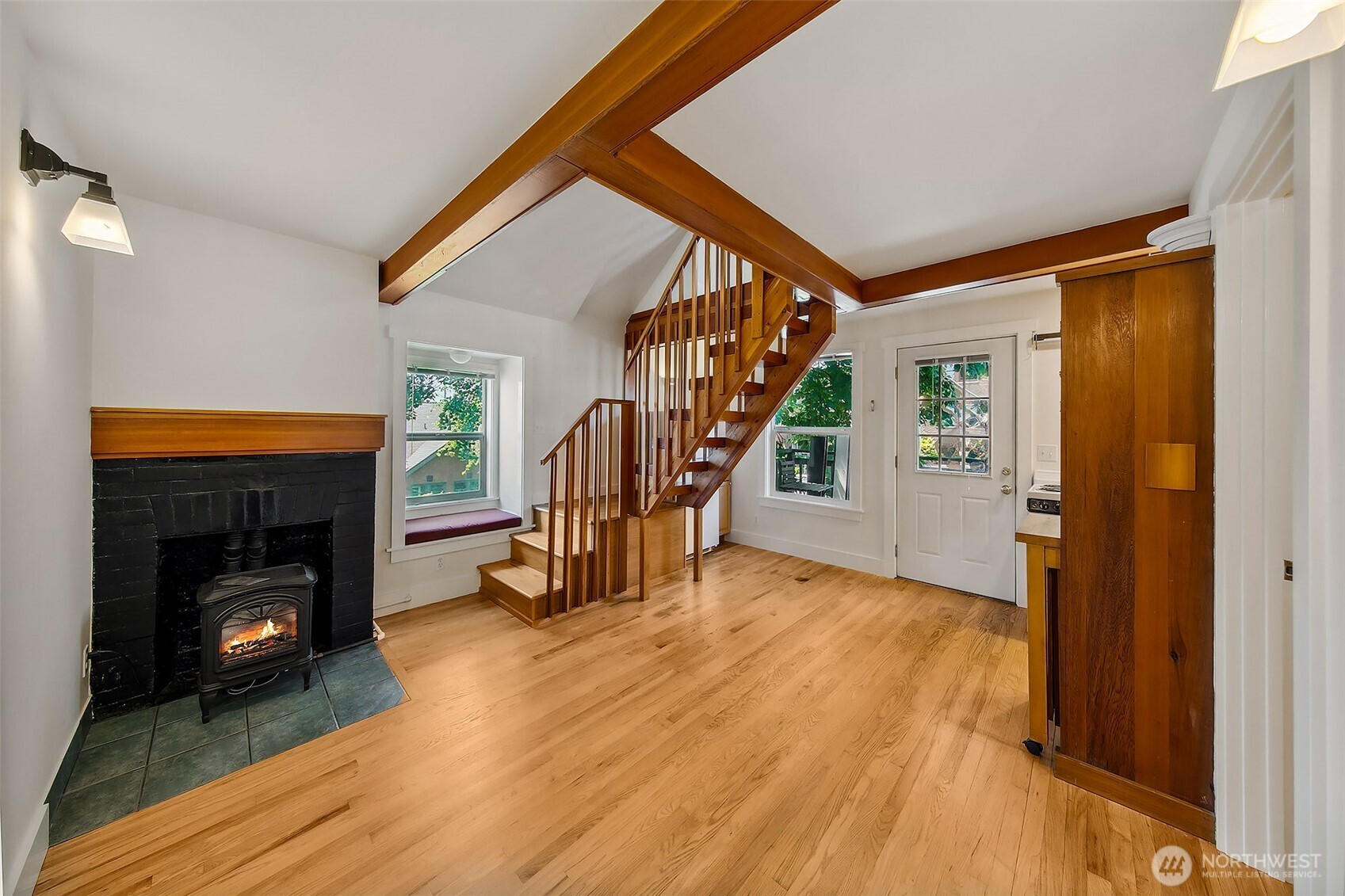 1111 18th Avenue Seattle, WA 98122 - Photo 24 of 40 a view of an entryway with wooden floor fireplace and a window