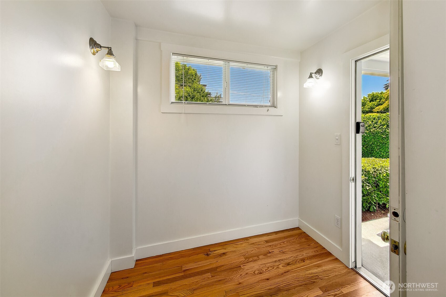 1111 18th Avenue Seattle, WA 98122 - Photo 32 of 40 a view of an empty room with window and wooden floor