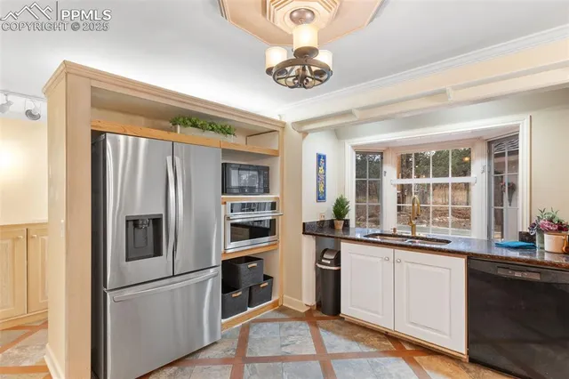 a kitchen with stainless steel appliances a refrigerator and a sink