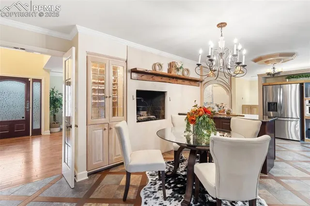 a view of a dining room with furniture wooden floor and a chandelier