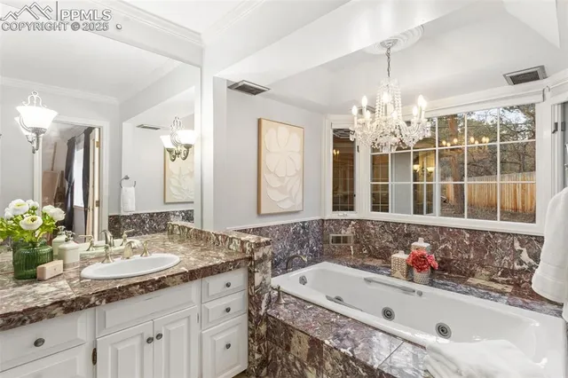 a bathroom with a bathtub sink and large mirror