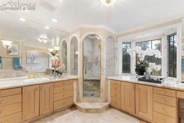a spacious bathroom with a double vanity sink a large mirror and a shower