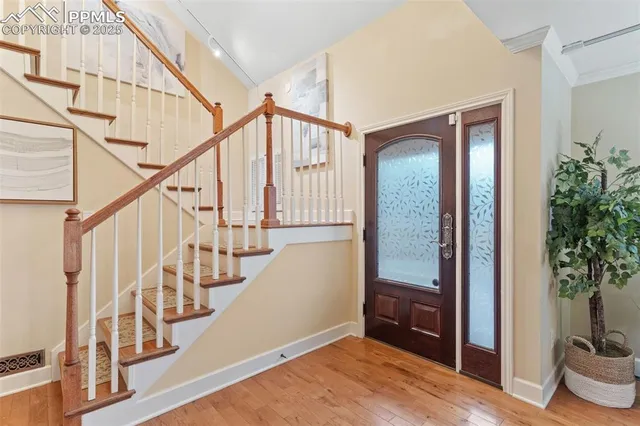 a view of entryway with wooden floor and stairs