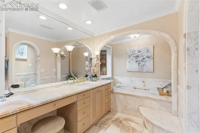 a spacious bathroom with a granite countertop sink mirror and bathtub