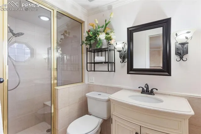 a bathroom with a sink vanity mirror and toilet