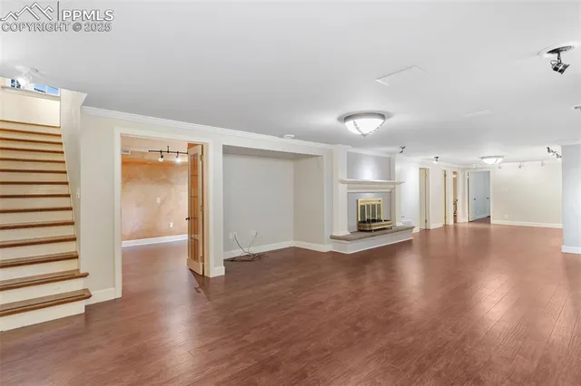 a view of empty room with wooden floor