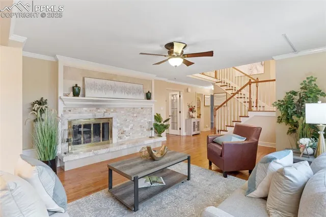 a living room with furniture a fireplace and a potted plant