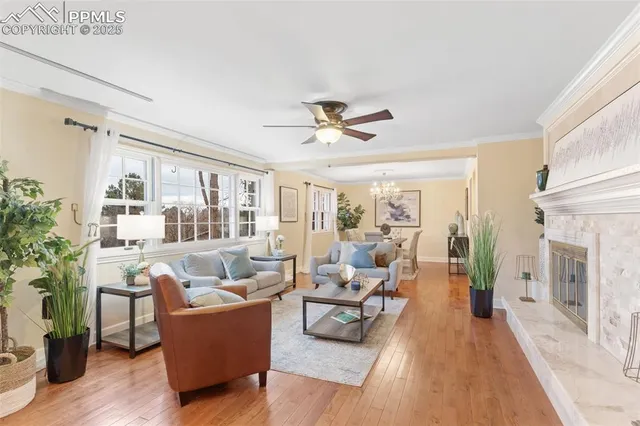 a living room with furniture fireplace and a large window