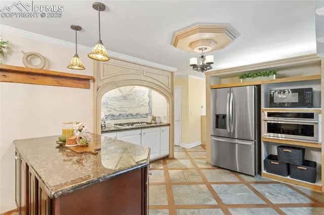 a kitchen with stainless steel appliances granite countertop a sink refrigerator and cabinets