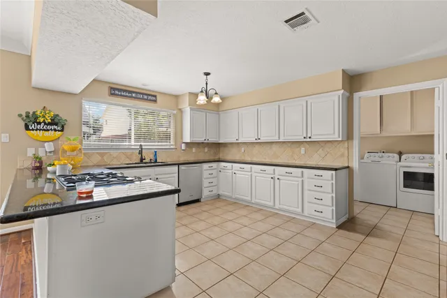 a kitchen with stainless steel appliances granite countertop a stove sink and cabinets
