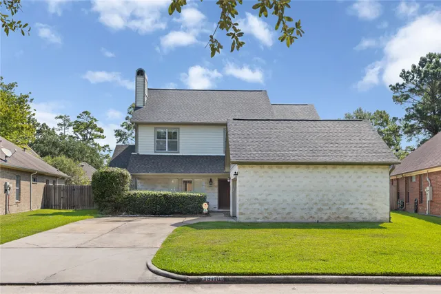 a view of a house with a yard and a patio