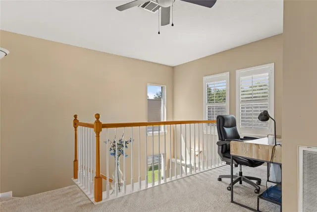 a view of a room with furniture and windows