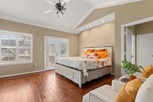 a bedroom with a bed wooden floor and window