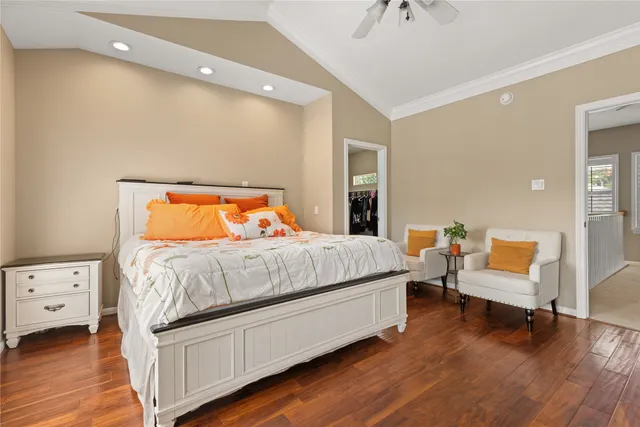 a bedroom with a bed and a lounge chair