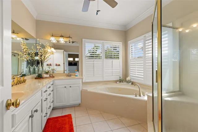 a spacious bathroom with a tub sink and mirror