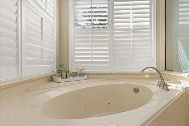 a bathroom with bathtub and window