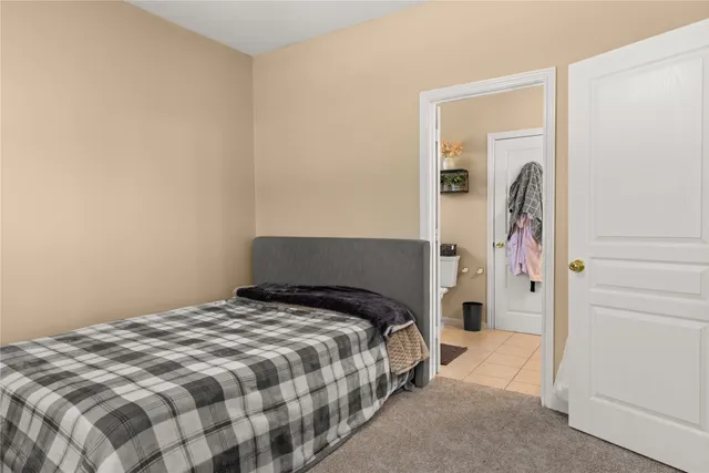 a bedroom with a bed and a painting on the wall