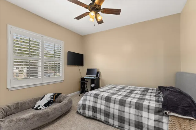 a bedroom with a bed and a television