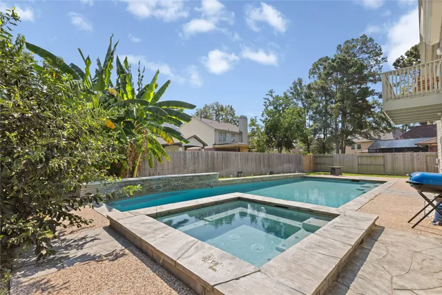 a view of a backyard with swimming pool