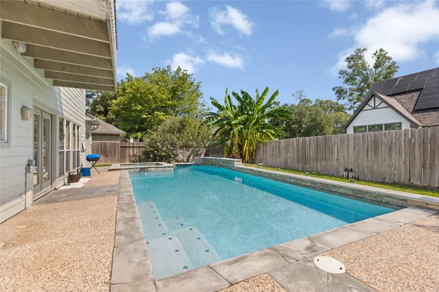 a view of a house with swimming pool and sitting area
