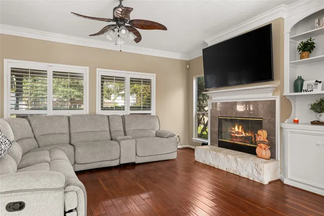 a living room with furniture a flat screen tv and a fireplace