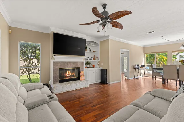 a living room with furniture a flat screen tv and a fireplace