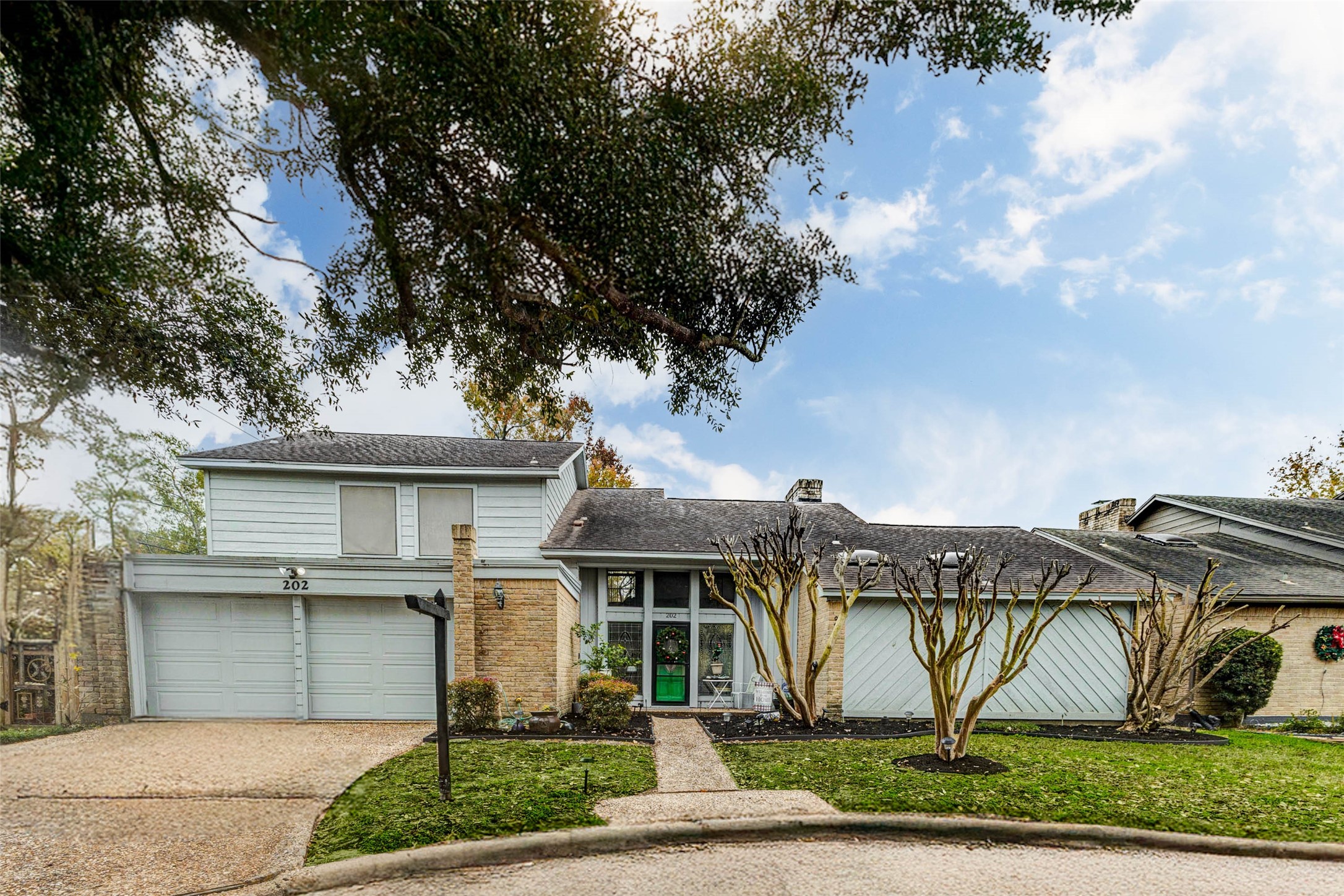202 Old Bridge Lake Street Houston, TX 77069 - Photo 2 of 27 a view of a white house next to a yard with big trees