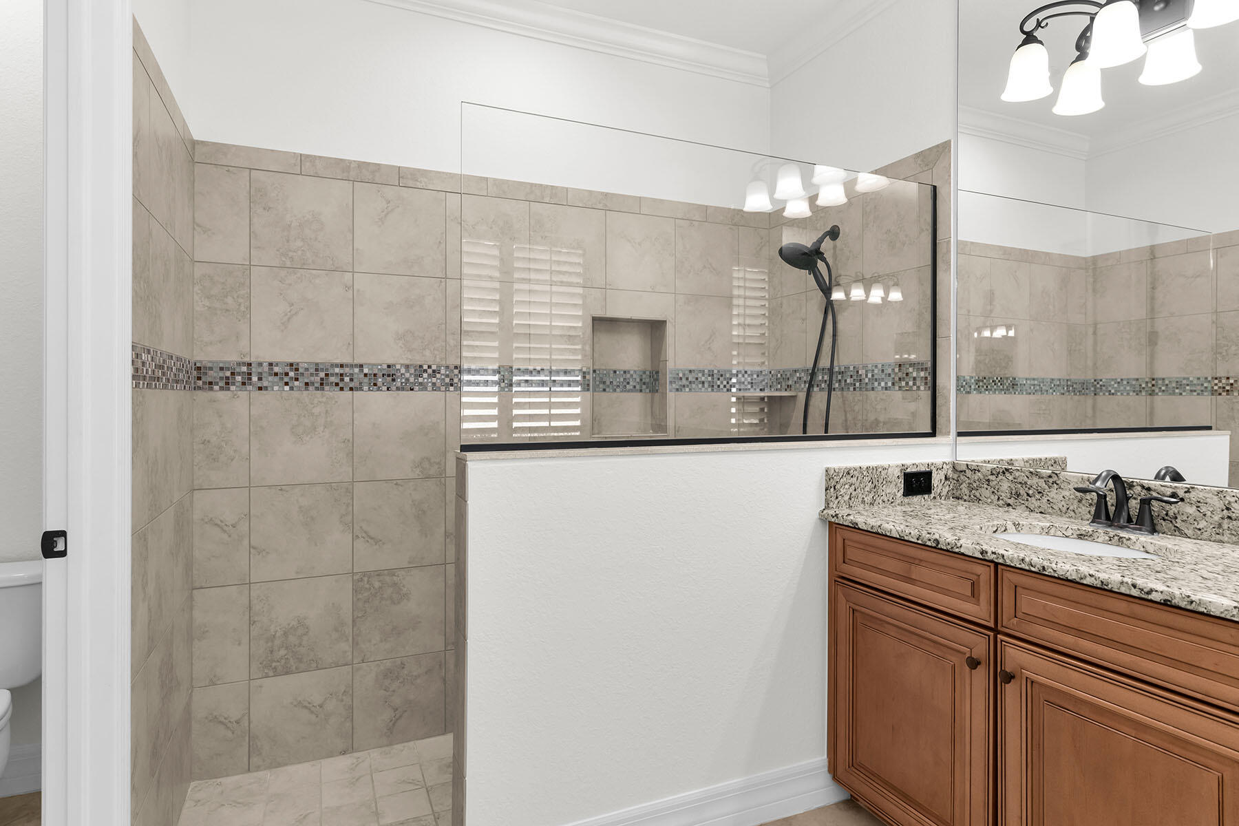2990 Aviamar Circle Naples, FL 34114 - Photo 18 of 44 a bathroom with a granite countertop sink a mirror and shower