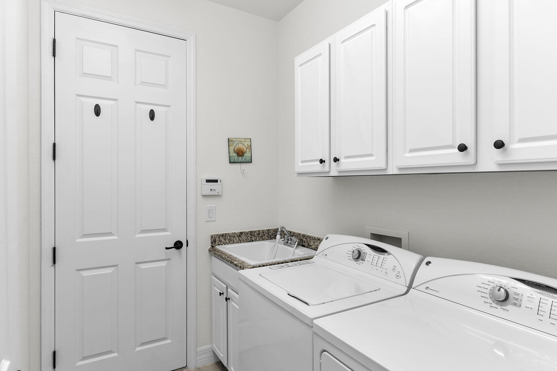 2990 Aviamar Circle Naples, FL 34114 - Photo 23 of 44 a utility room with dryer and washer