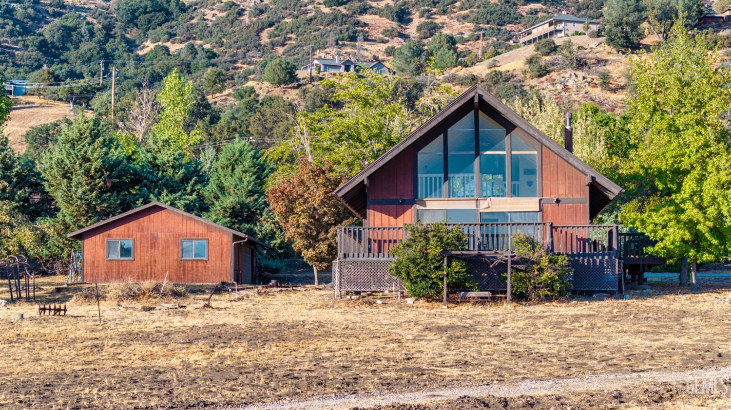 Undisclosed Address Tehachapi, CA 93561 - Photo 2 of 37 a backyard of a house with wooden fence and a tree