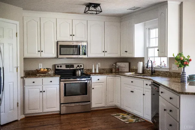 a view of a dining room with furniture wooden floor and chandelier