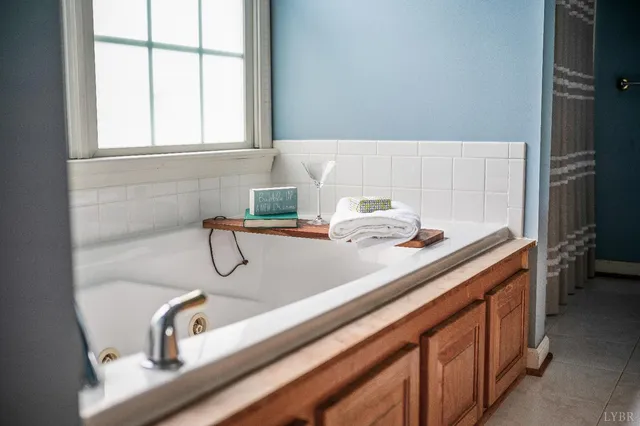 a bedroom with bed chair and window