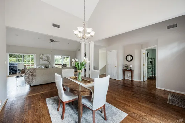 a living room with furniture wooden floor and a large window