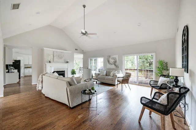 a living room with furniture and floor to ceiling windows