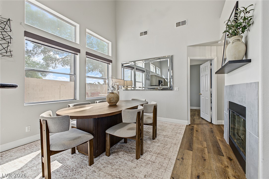 2376 Ramsgate Drive Henderson, NV 89074 - Photo 11 of 25 Towering ceilings and a sleek modern fireplace elevate this light-filled dining space.