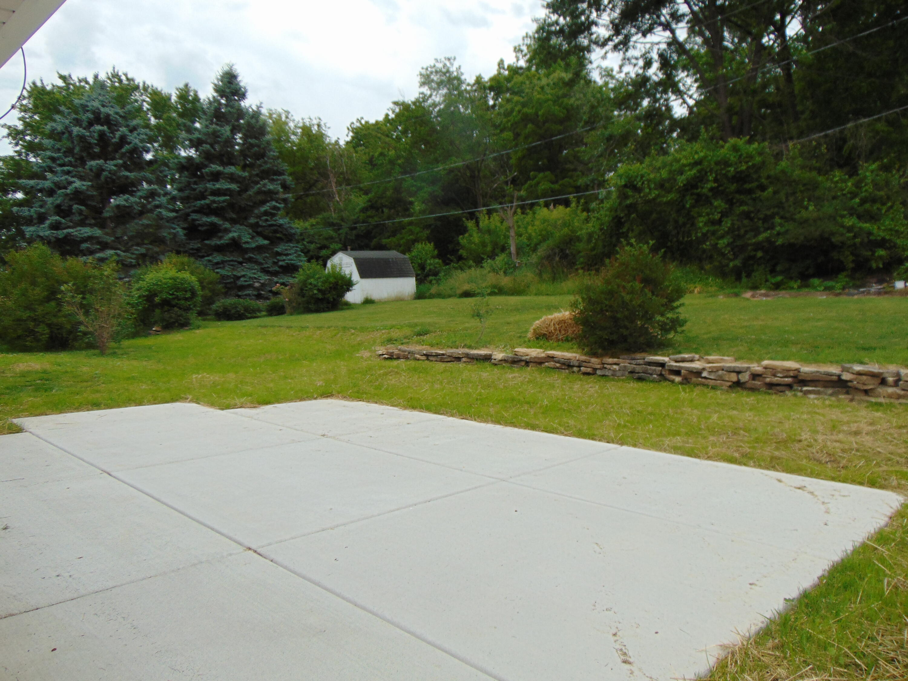 517 Maple Street Mukwonago, WI 53149 - Photo 27 of 30 Back Yard Retaining Wall