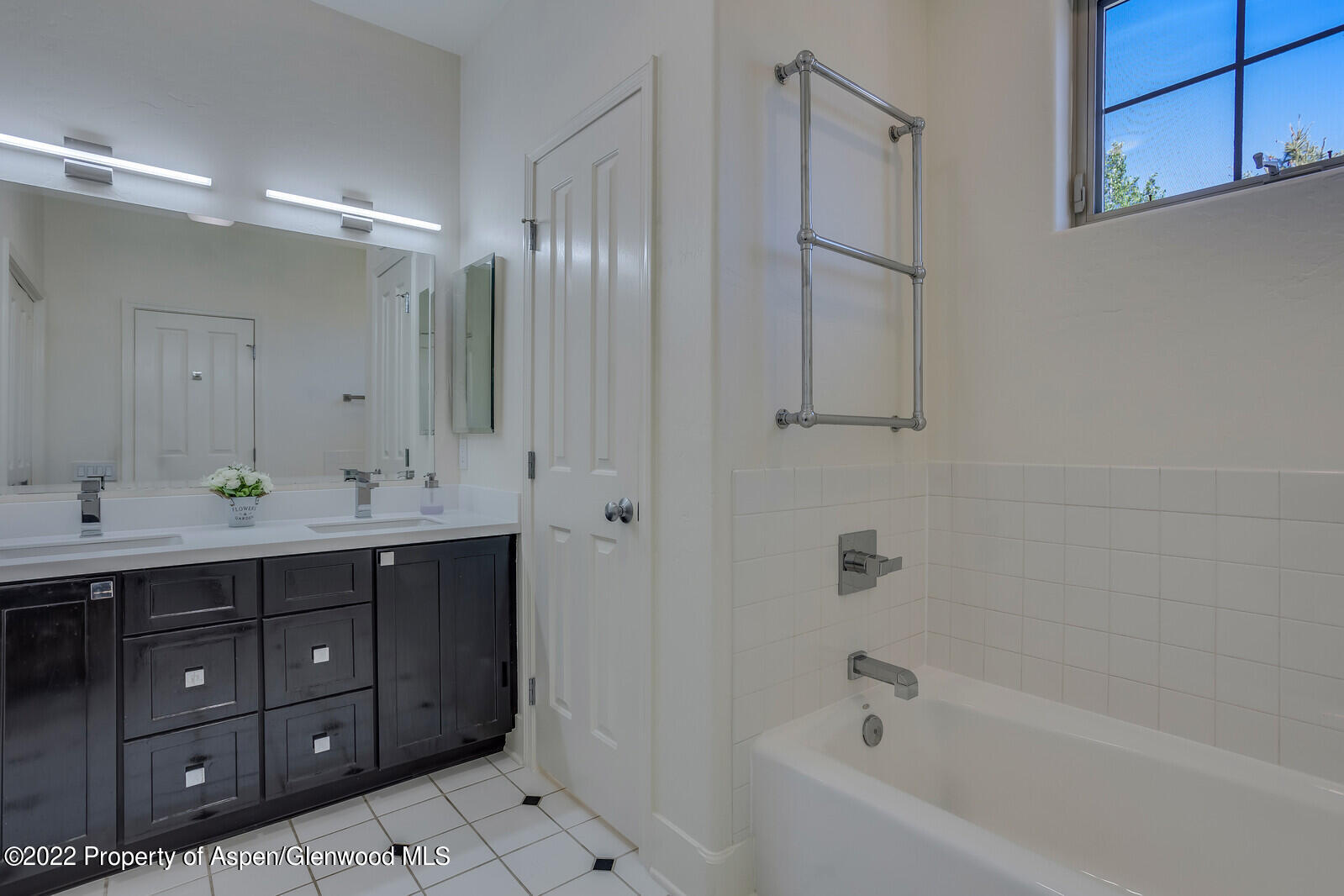 620 Evans Court Basalt, CO 81621 - Photo 23 of 35 a bathroom with a double vanity sink a large mirror and shower