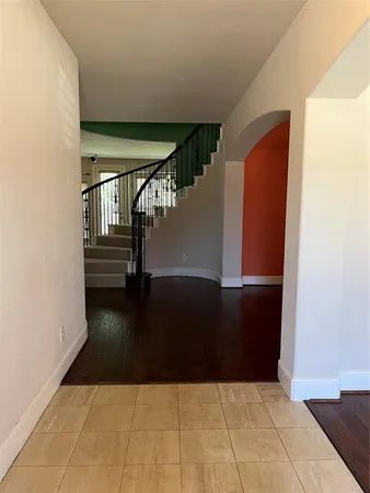 a view of entryway and hall with wooden floor