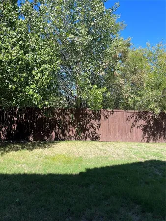 a view of yard with swimming pool and green space