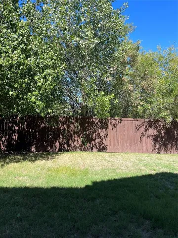 a view of yard with swimming pool and green space