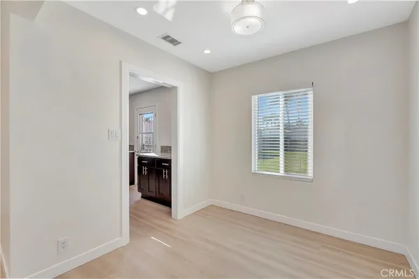 an empty room with closet and a window