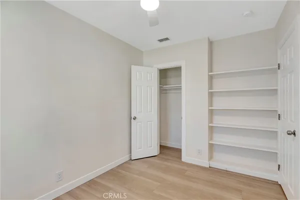 a view of an empty room with a closet