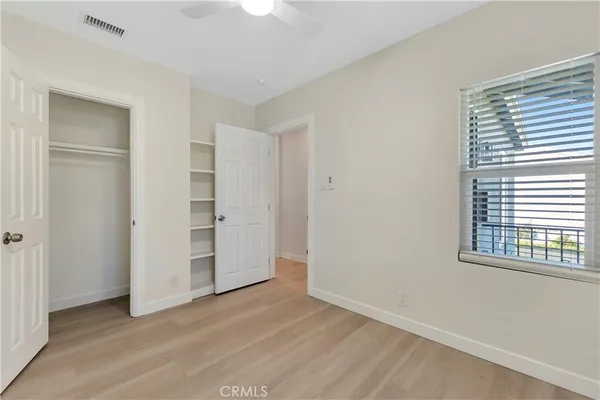 an empty room with windows and closet