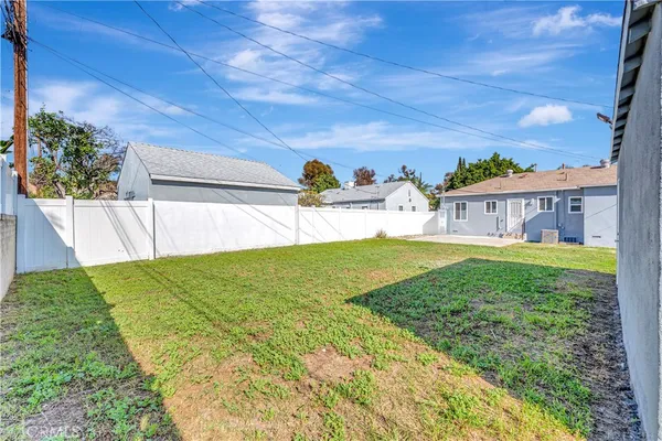 a view of house with backyard and a garden